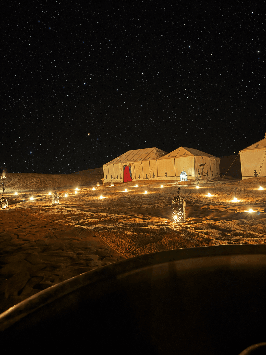 Luxury desert camp tents set among Sahara dunes at Erg Chigaga in Morocco.