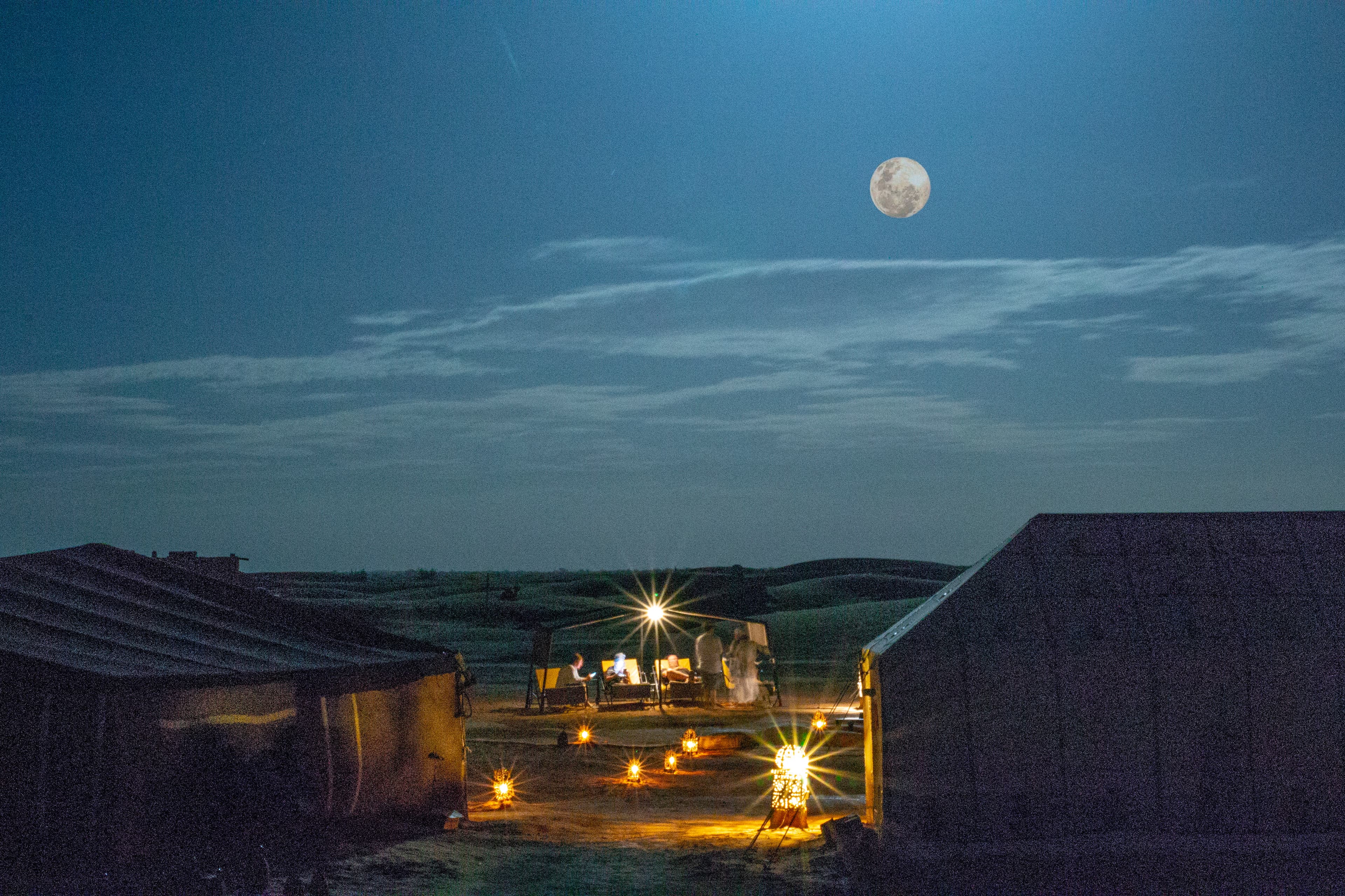 Moonlit camp atmosphere in the Sahara desert.