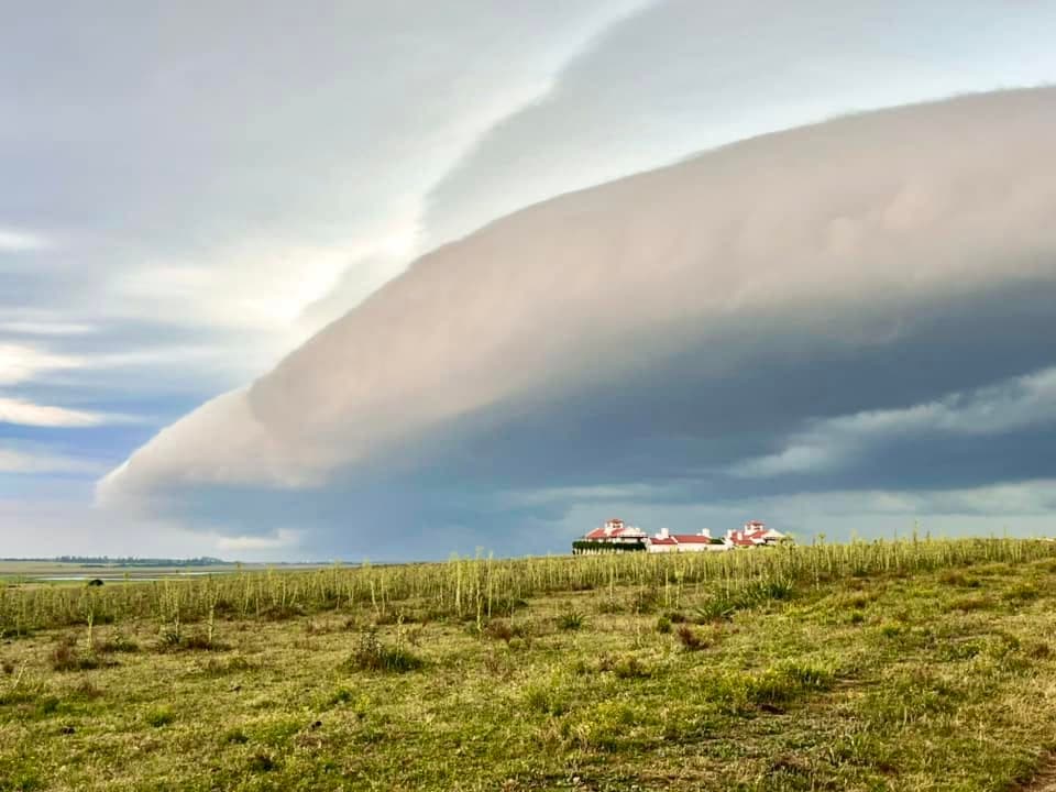 A dramatic cloud rolling over a hacienda landscape in Uruguay.